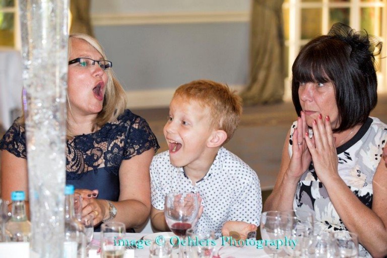 Woman and child in complete shock at wedding table magic